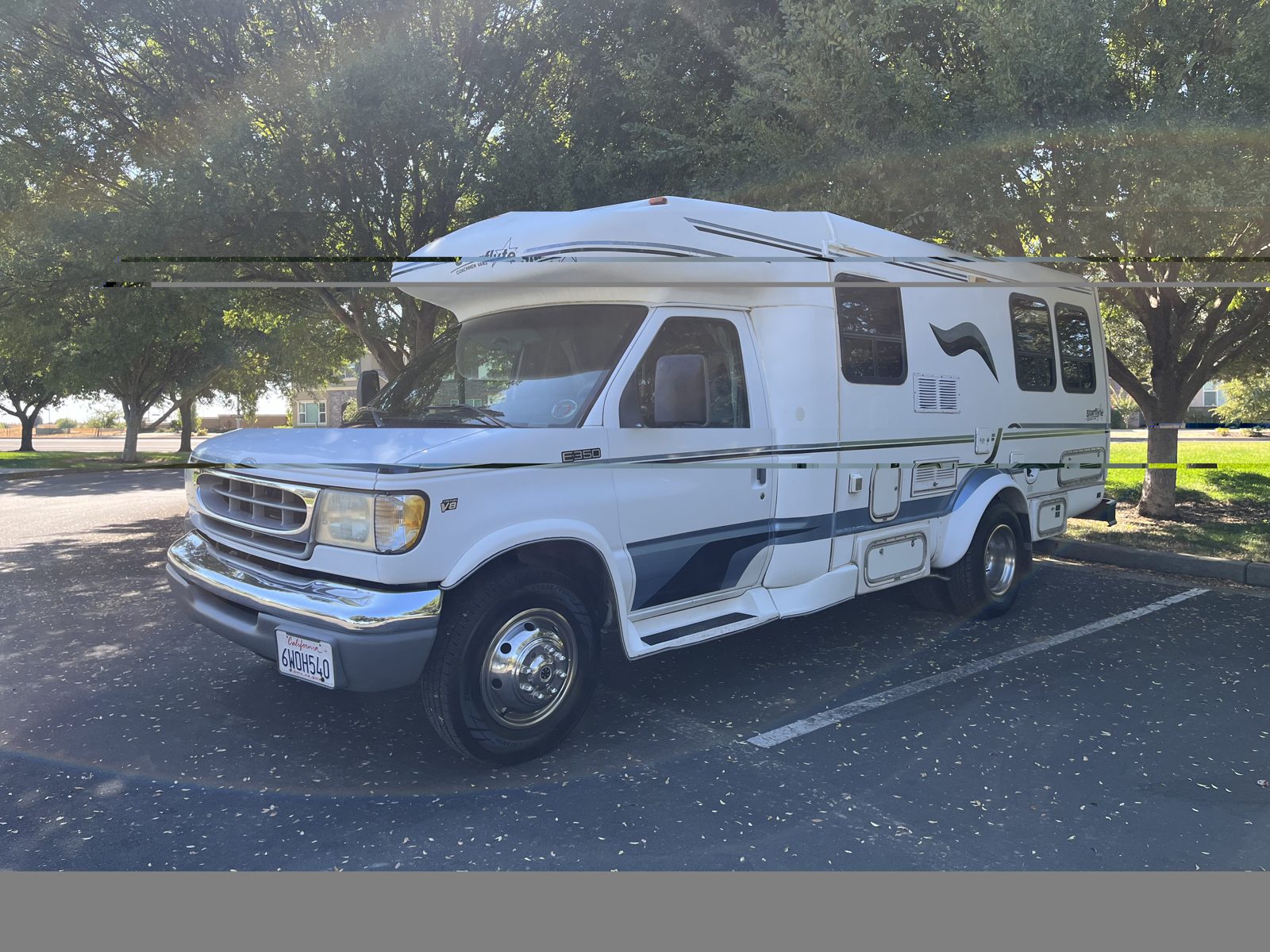 Ford Class B plus camper van with raised roof purchased in California